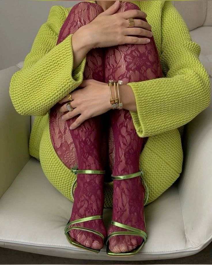 Lime knit cardigan over burgundy lace tights and green metallic sandals.